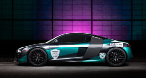 Audi R8 against purple industrial background, lit with light painting technique by Radiant Photography.